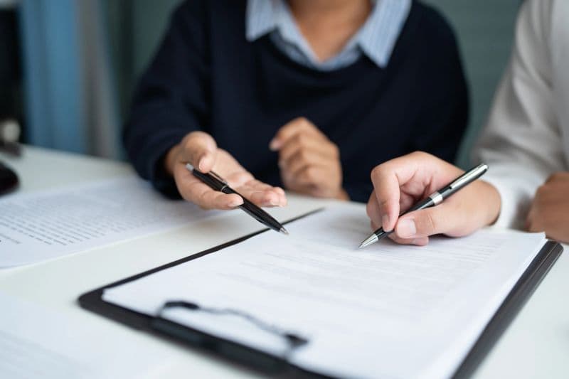 Professionals reviewing insurance documents